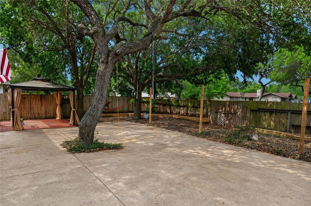 2328 Timberleaf Circle Ingleside, TX 78362 - Photo 30 of 33 a tree in front of a white house