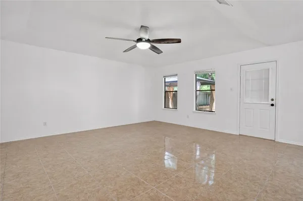 a view of a livingroom with a ceiling fan and window