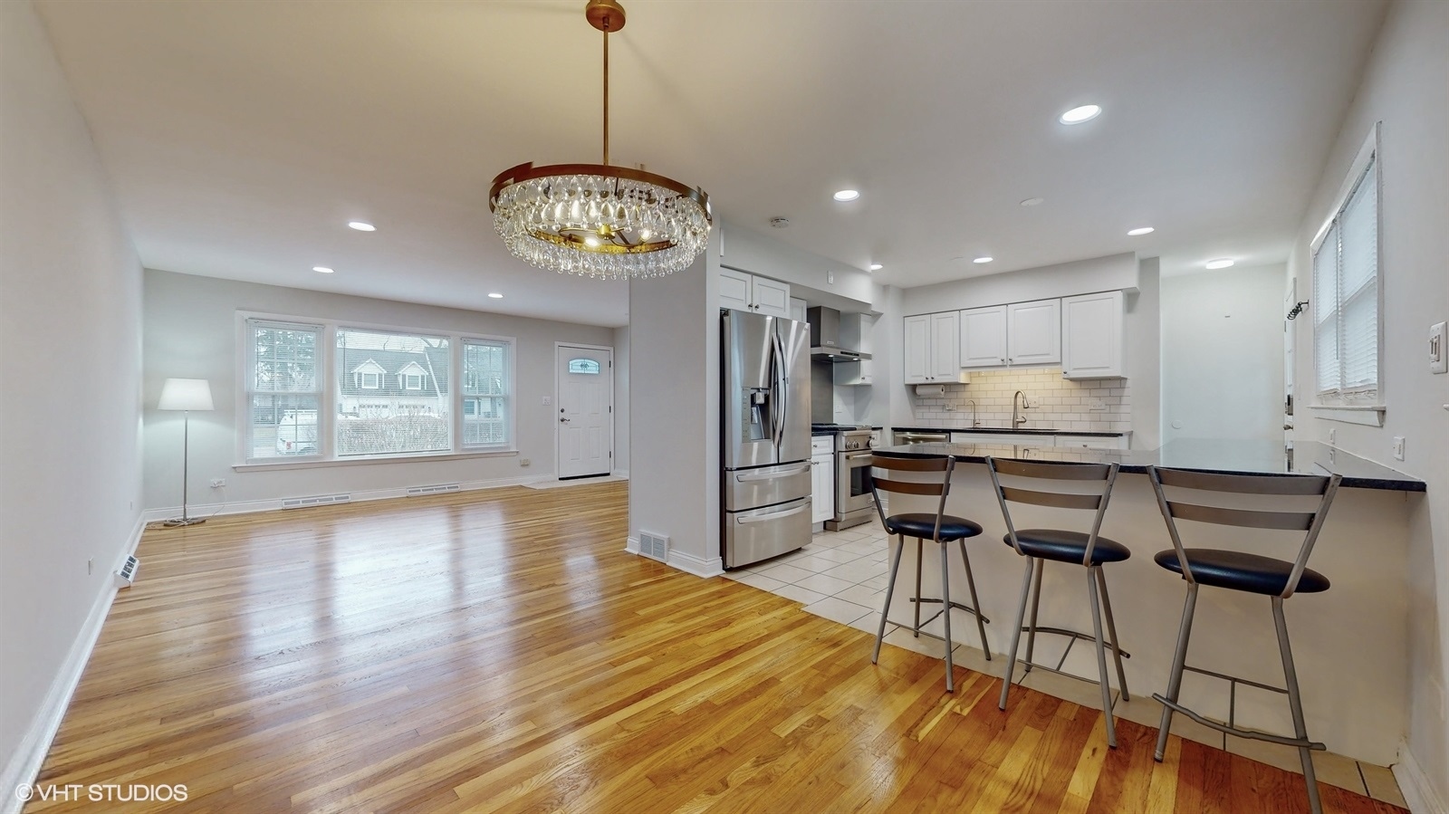 2930 Koepke Road Northbrook, IL 60062 - Photo 8 of 30 a view of a kitchen with stainless steel appliances granite countertop wooden floor and a chandelier