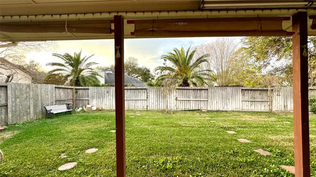 a view of a backyard with plants and a lake view
