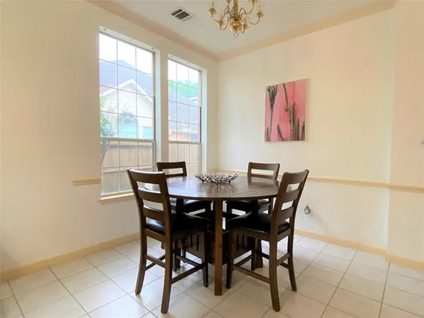 a view of a dining room with furniture and window
