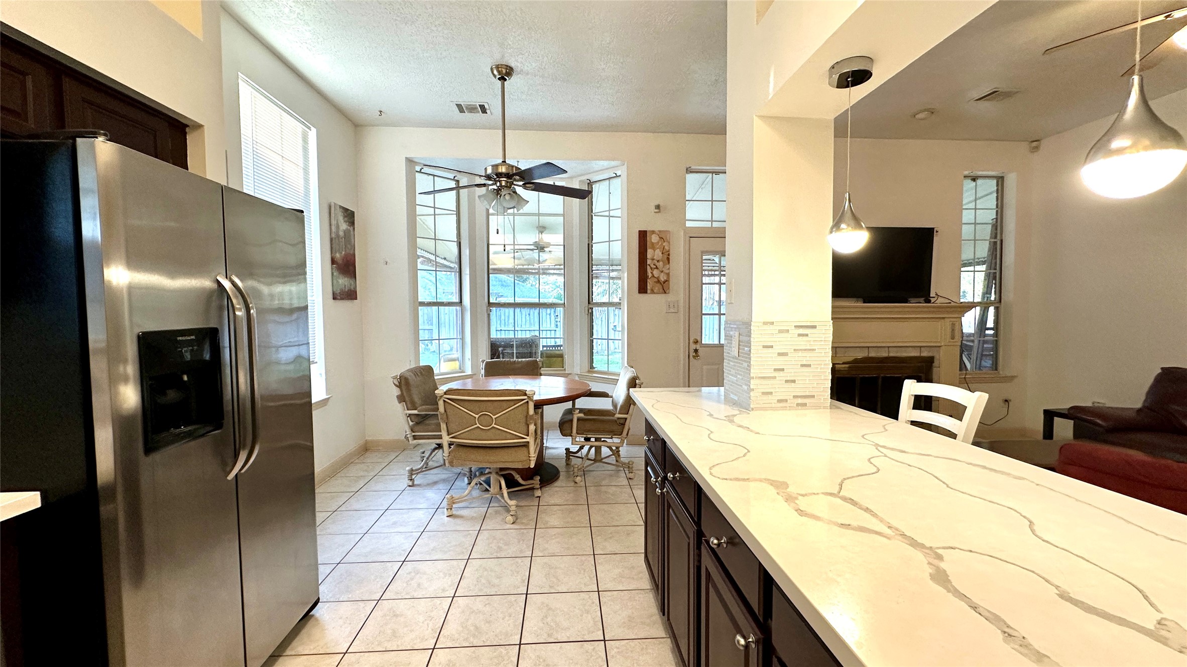 6918 Springcrest Court Sugar Land, TX 77479 - Photo 8 of 29 a kitchen with stainless steel appliances kitchen island granite countertop a refrigerator and a stove top oven