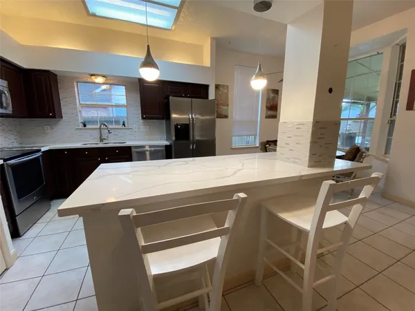 a dining room with furniture and chandelier