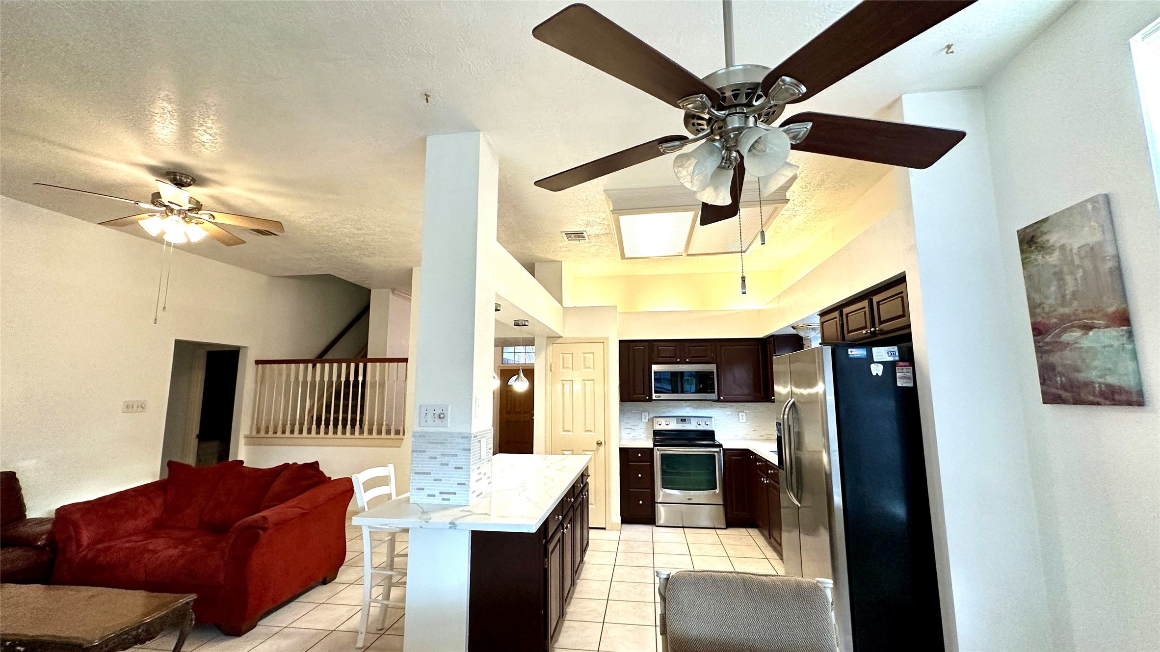 6918 Springcrest Court Sugar Land, TX 77479 - Photo 9 of 29 a living room with stainless steel appliances furniture and a chandelier
