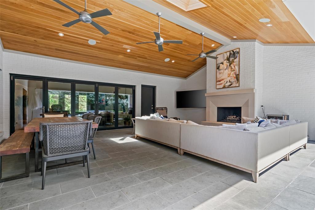 6117 Merrymount Road Westover Hills, TX 76107 - Photo 34 of 39 Living room with a high wooden beamed ceiling, a fireplace, ceiling fan, brick wall, and light tile patterned floors