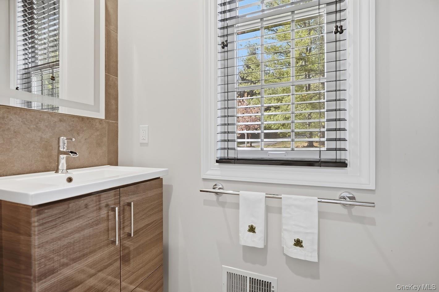 72 Burr Farms Road Mount Kisco, NY 10549 - Photo 11 of 28 a bathroom with a sink and a mirror