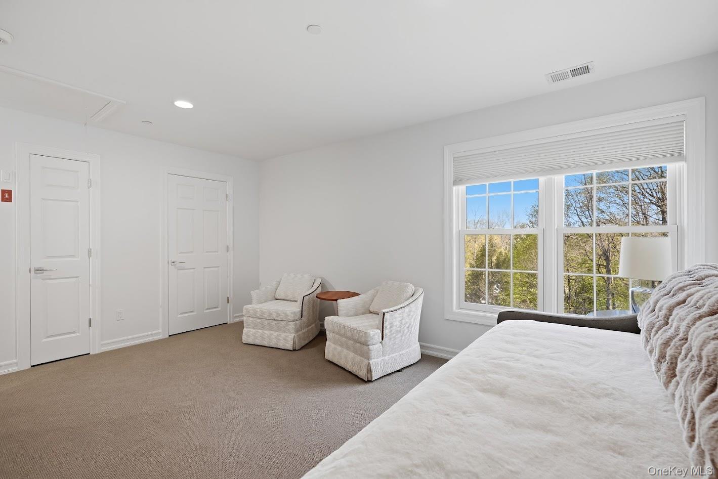 72 Burr Farms Road Mount Kisco, NY 10549 - Photo 13 of 28 a spacious bedroom with a bed and a large window