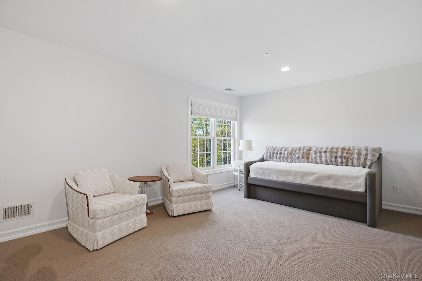 72 Burr Farms Road Mount Kisco, NY 10549 - Photo 14 of 28 a spacious bedroom with a bed and a couch