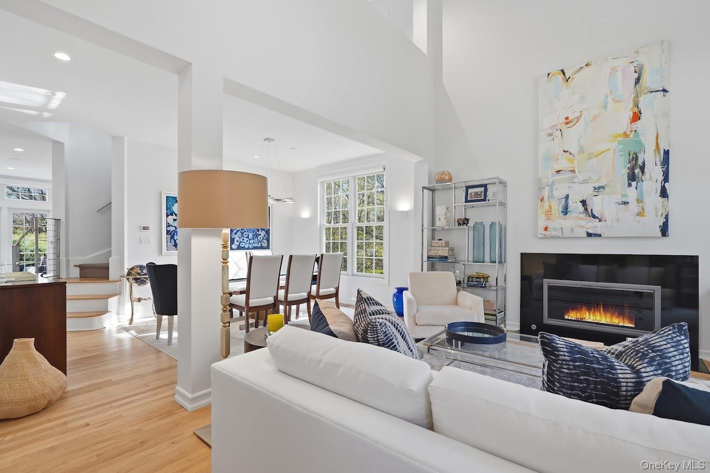 72 Burr Farms Road Mount Kisco, NY 10549 - Photo 2 of 28 a living room with furniture a fireplace and a flat screen tv