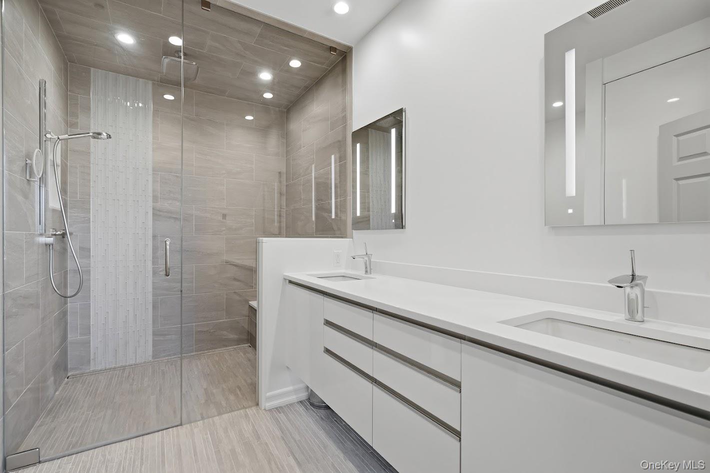 72 Burr Farms Road Mount Kisco, NY 10549 - Photo 10 of 28 a bathroom with a shower sink and mirror