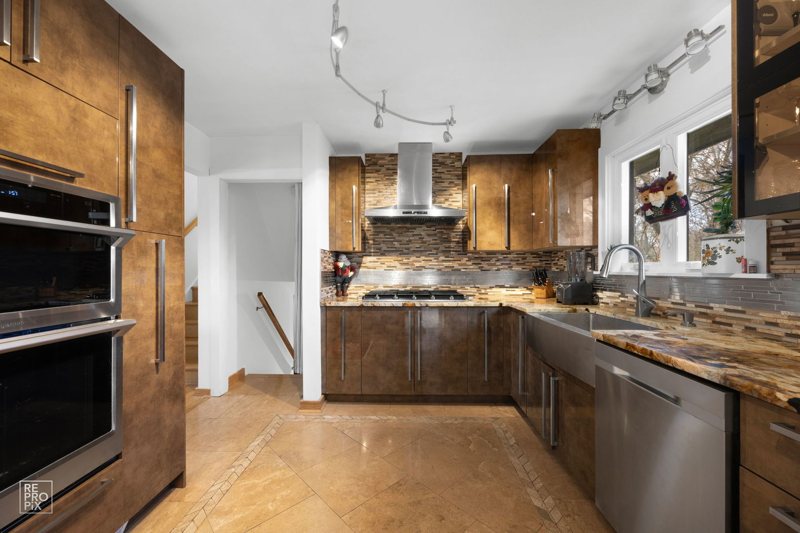 362 63rd Street Willowbrook, IL 60527 - Photo 11 of 25 a kitchen with stainless steel appliances granite countertop a stove a sink and a microwave