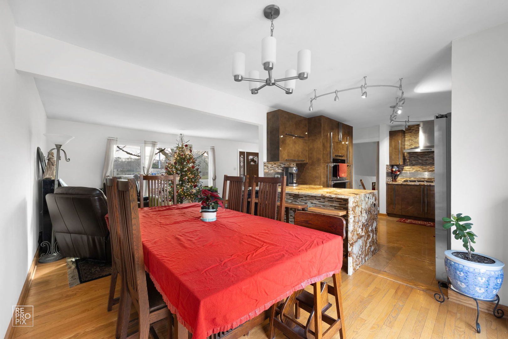 362 63rd Street Willowbrook, IL 60527 - Photo 14 of 25 a view of a dining room and livingroom with furniture wooden floor a chandelier