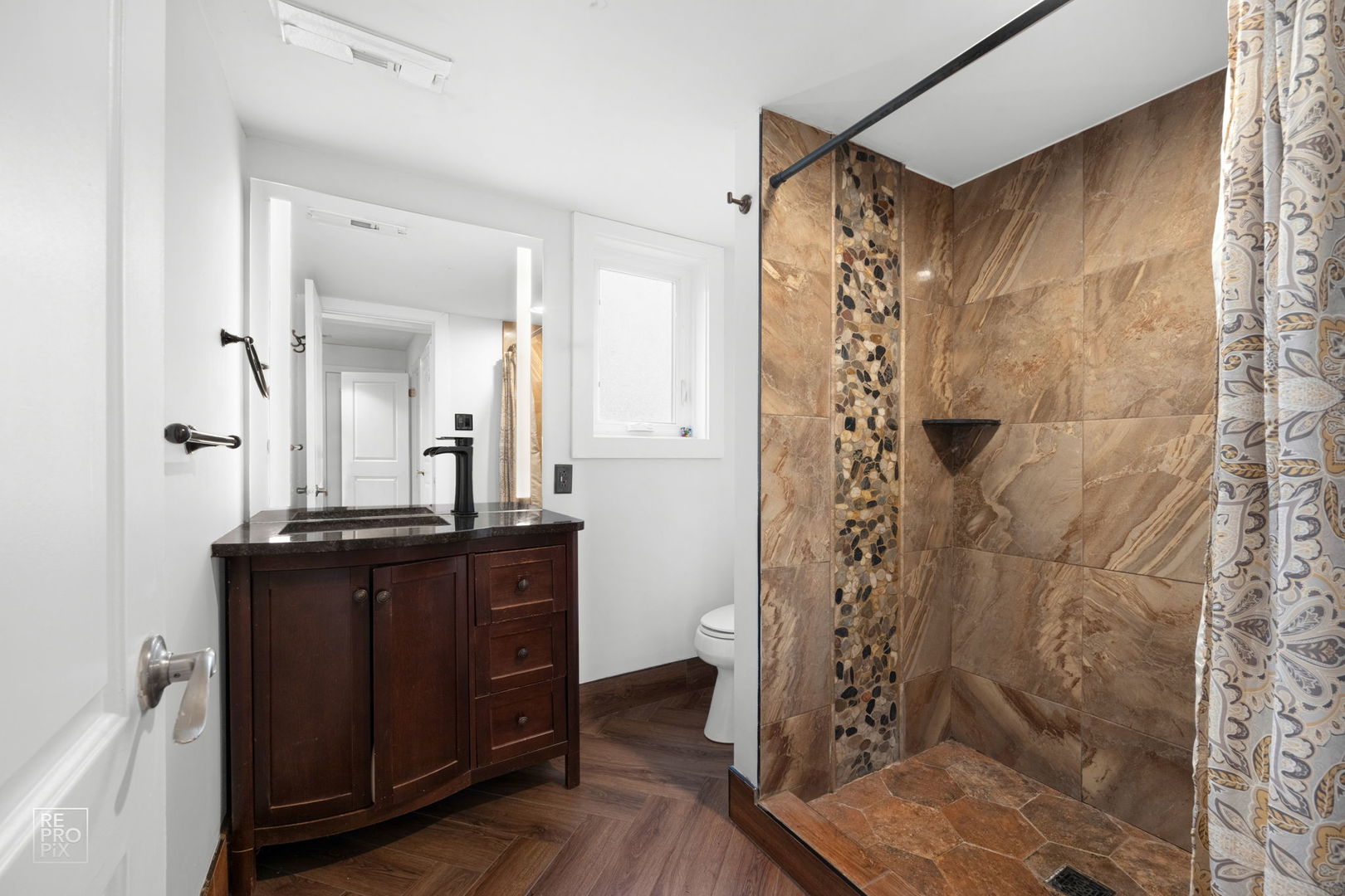 362 63rd Street Willowbrook, IL 60527 - Photo 19 of 25 a bathroom with a glass shower door and a sink