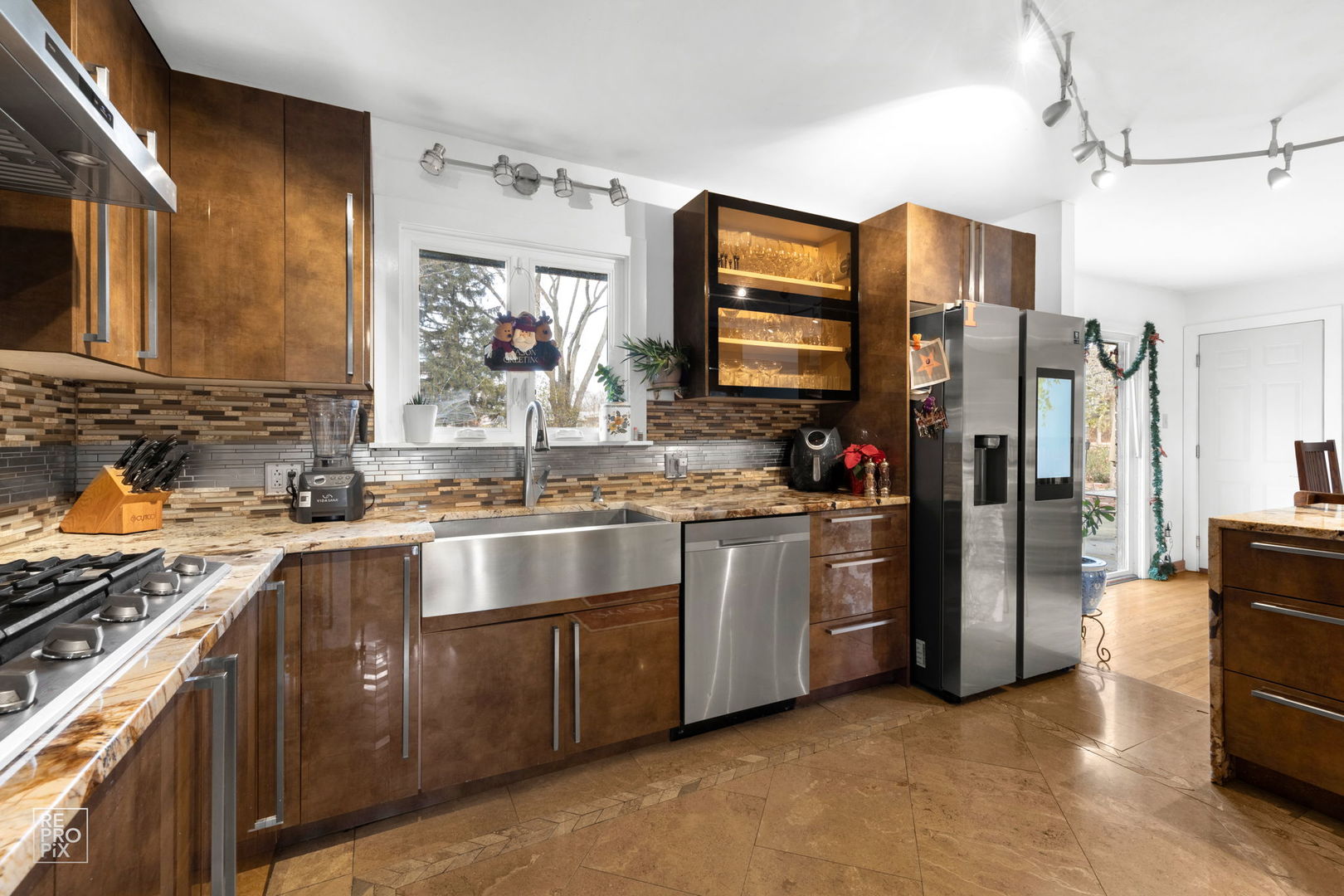 362 63rd Street Willowbrook, IL 60527 - Photo 5 of 25 a kitchen with stainless steel appliances granite countertop a sink stove and refrigerator