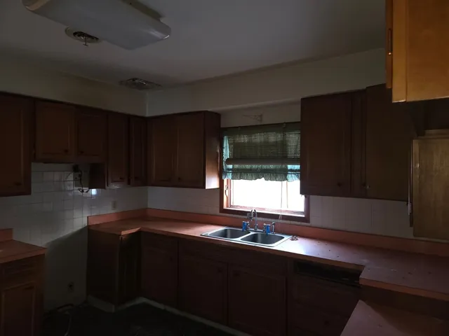 a kitchen with a sink cabinets and stainless steel appliances