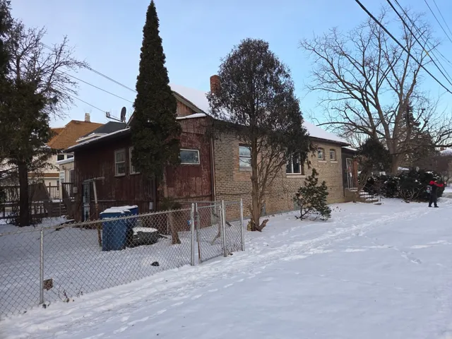 a view of a house with a yard and sitting area