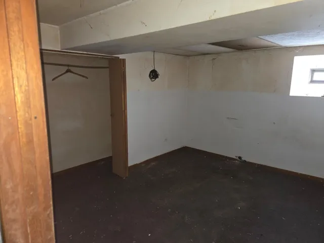 a bathroom with a toilet and a window