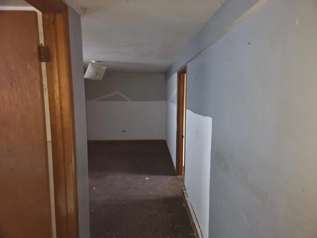 a utility room with a sink a cabinetry and a window