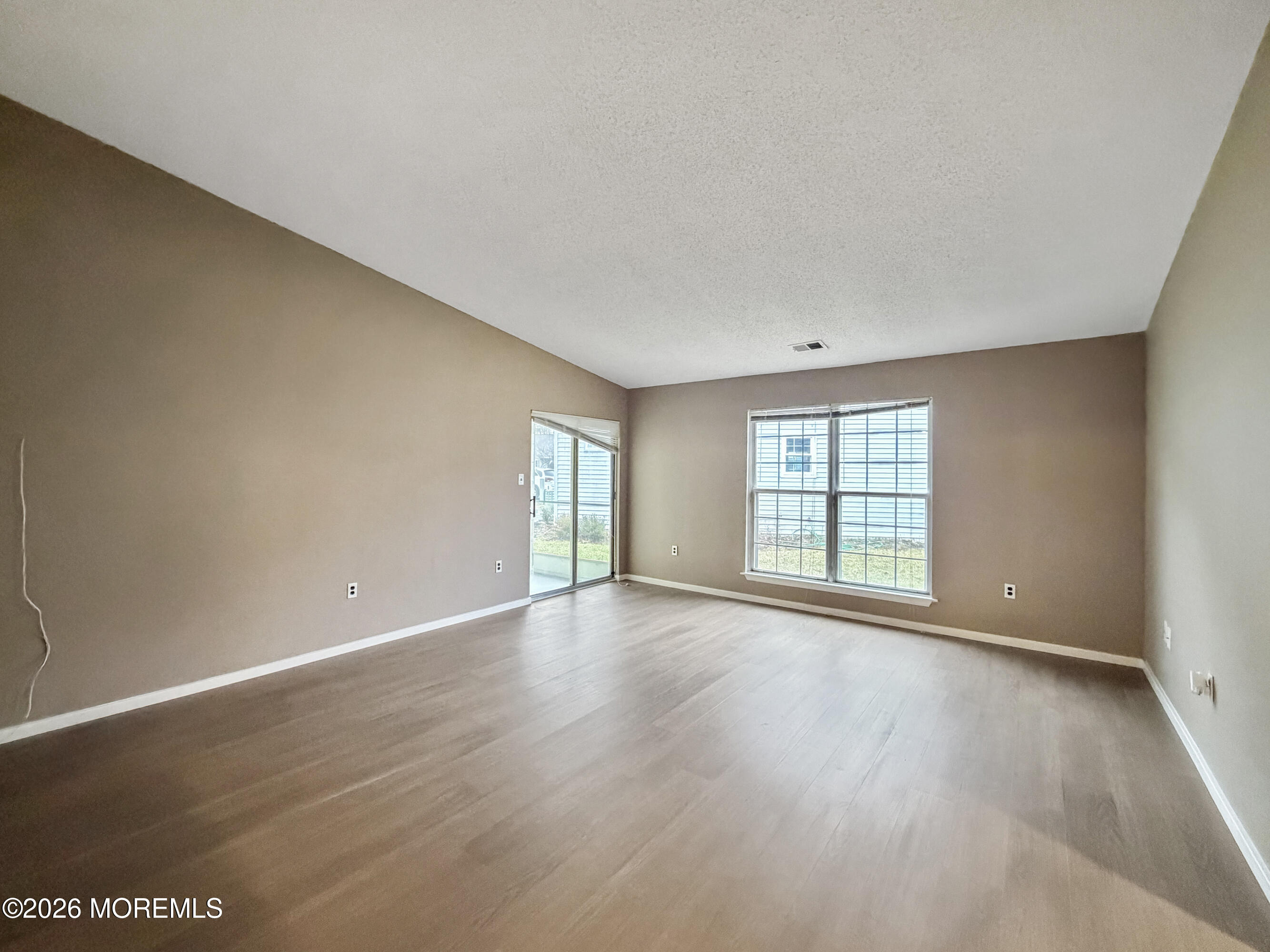 47 Carnaby Close Freehold, NJ 07728 - Photo 12 of 29 a view of an empty room with wooden floor and fan