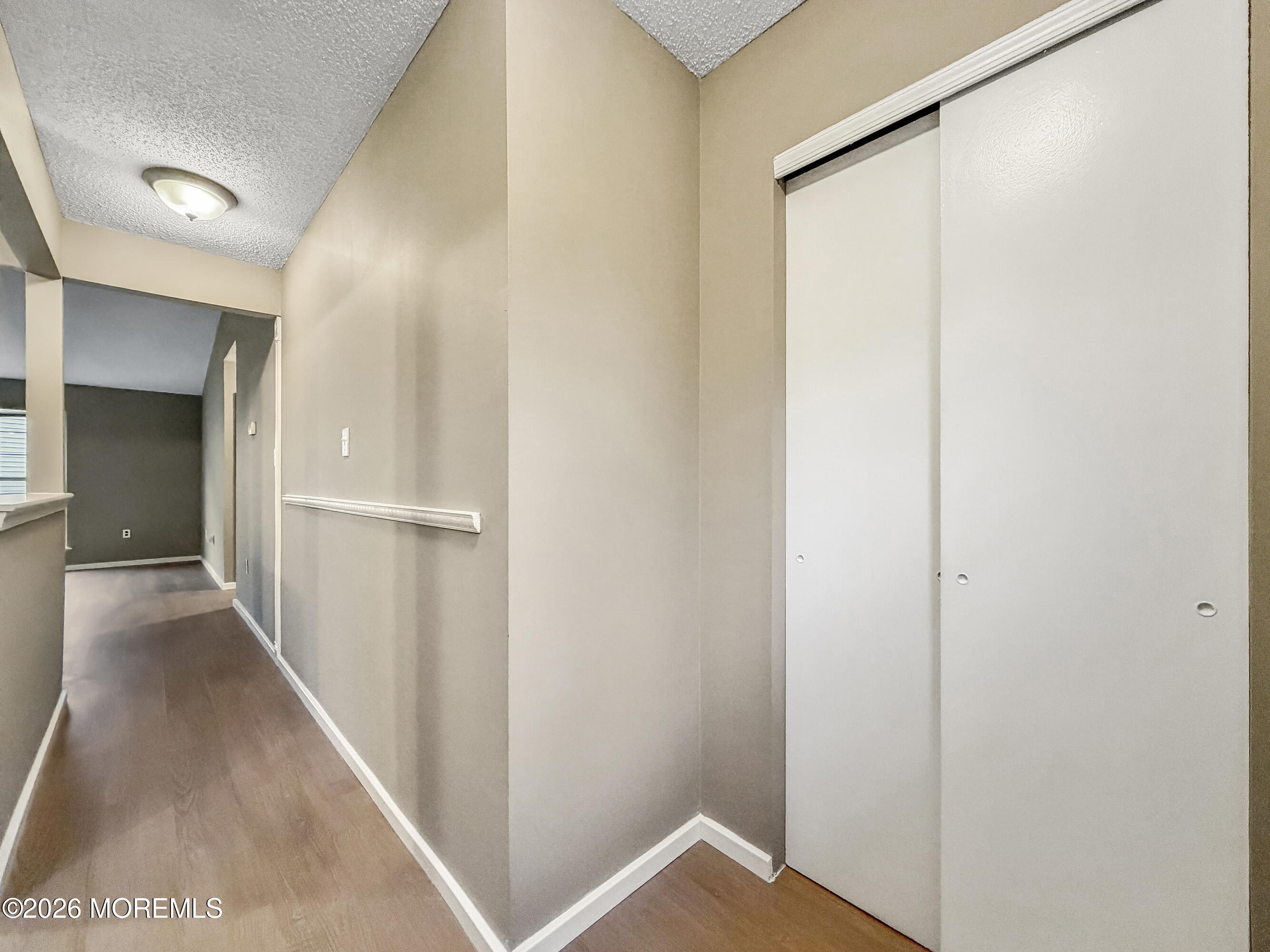 47 Carnaby Close Freehold, NJ 07728 - Photo 10 of 29 a view of a hallway with wooden floor