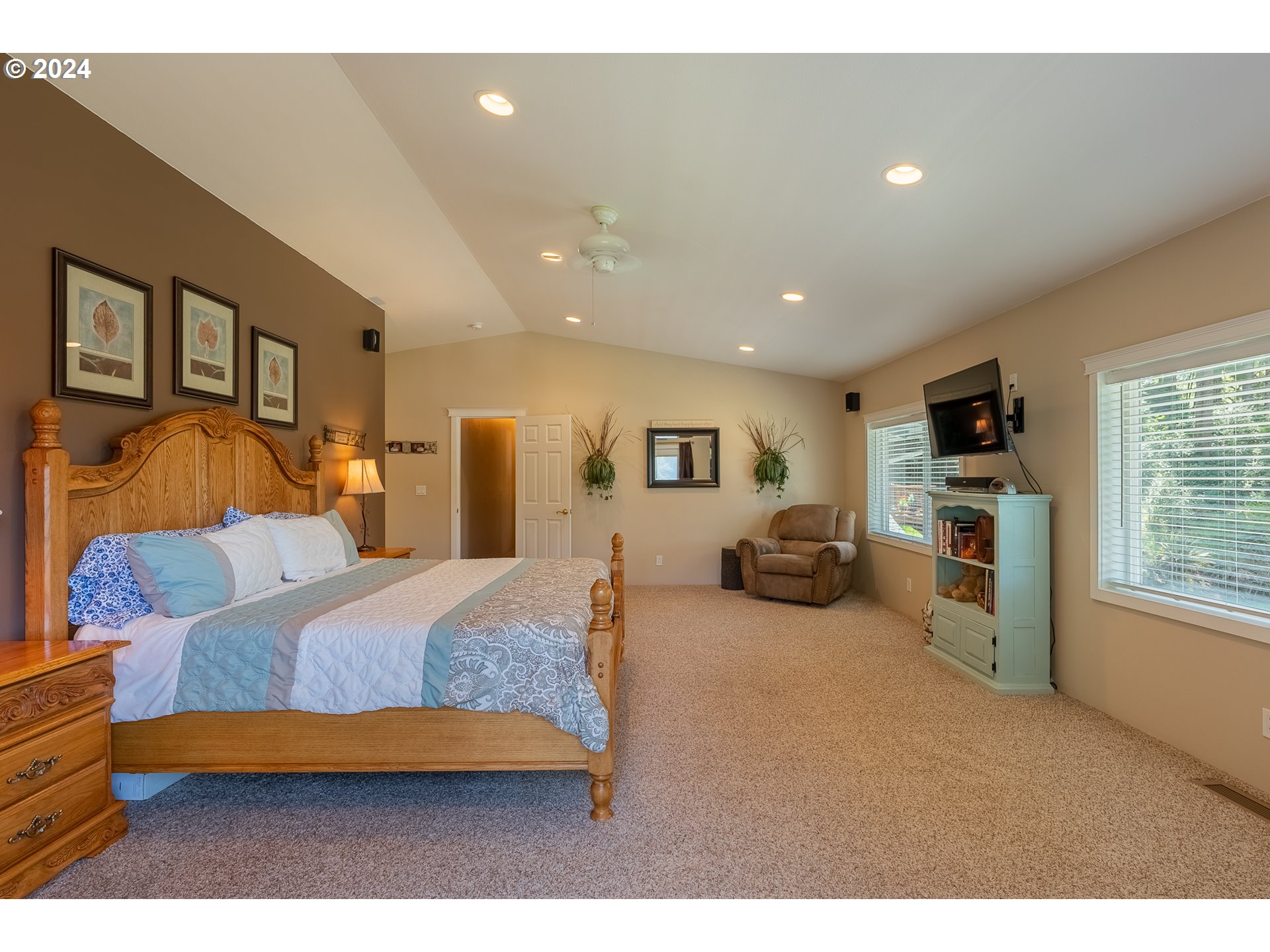 89915 Ben Bunch Road Florence, OR 97439 - Photo 17 of 33 a bedroom with furniture and a flat screen tv