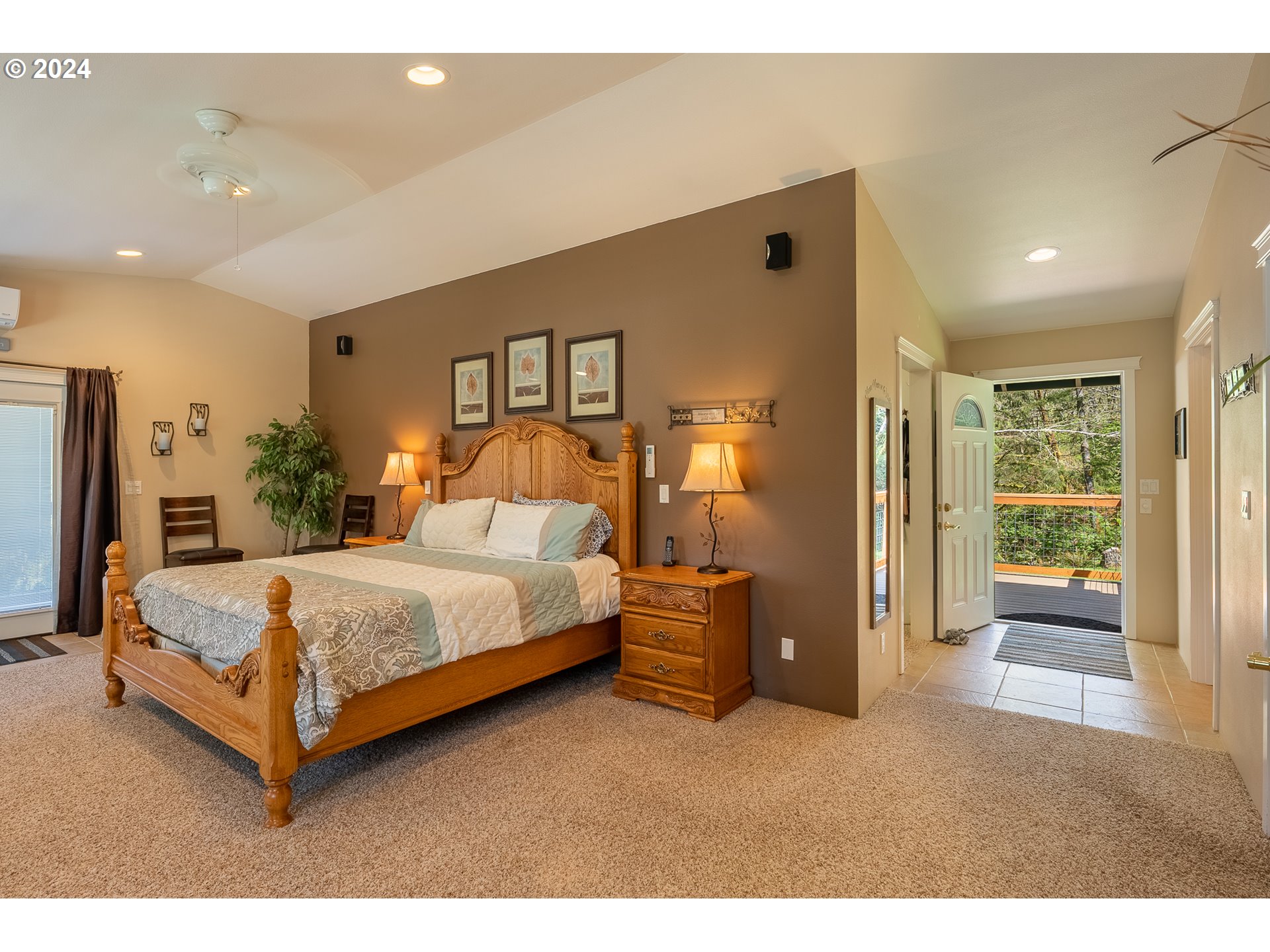 89915 Ben Bunch Road Florence, OR 97439 - Photo 18 of 33 a bedroom with a bed lamp and a large window