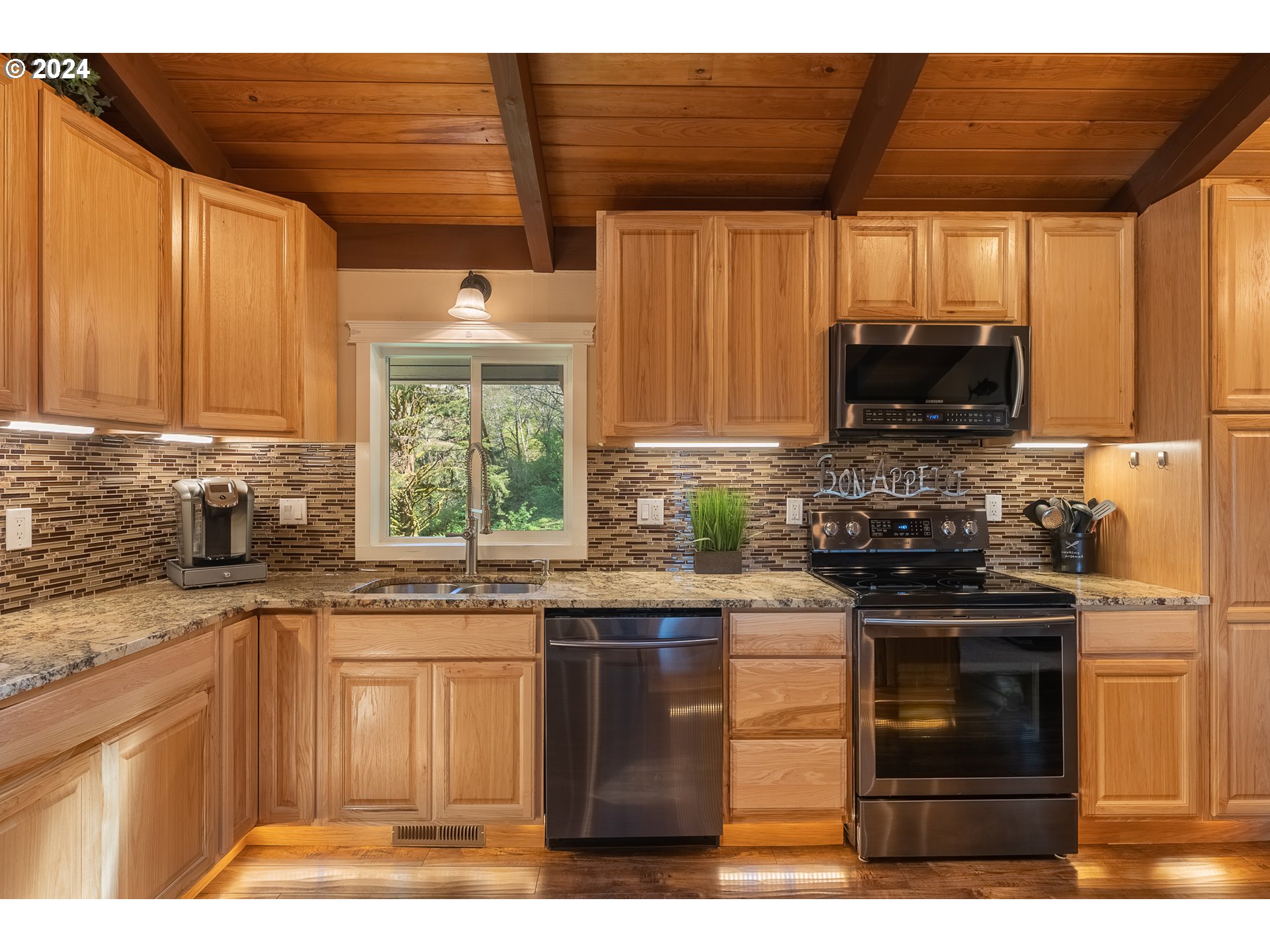 89915 Ben Bunch Road Florence, OR 97439 - Photo 2 of 33 a kitchen with stainless steel appliances granite countertop a stove a sink and a microwave
