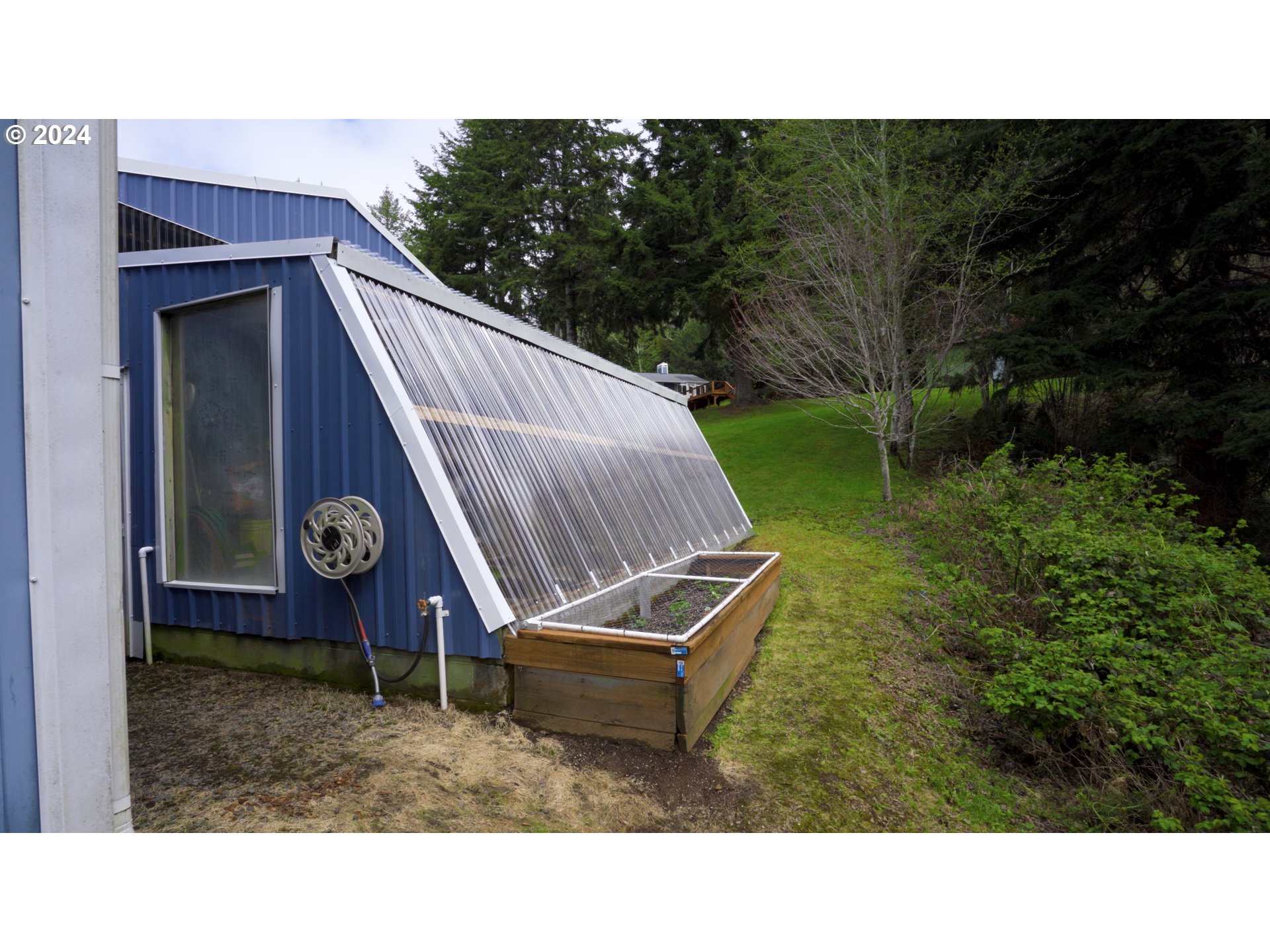 89915 Ben Bunch Road Florence, OR 97439 - Photo 24 of 33 a backyard of a house with a yard and trampoline