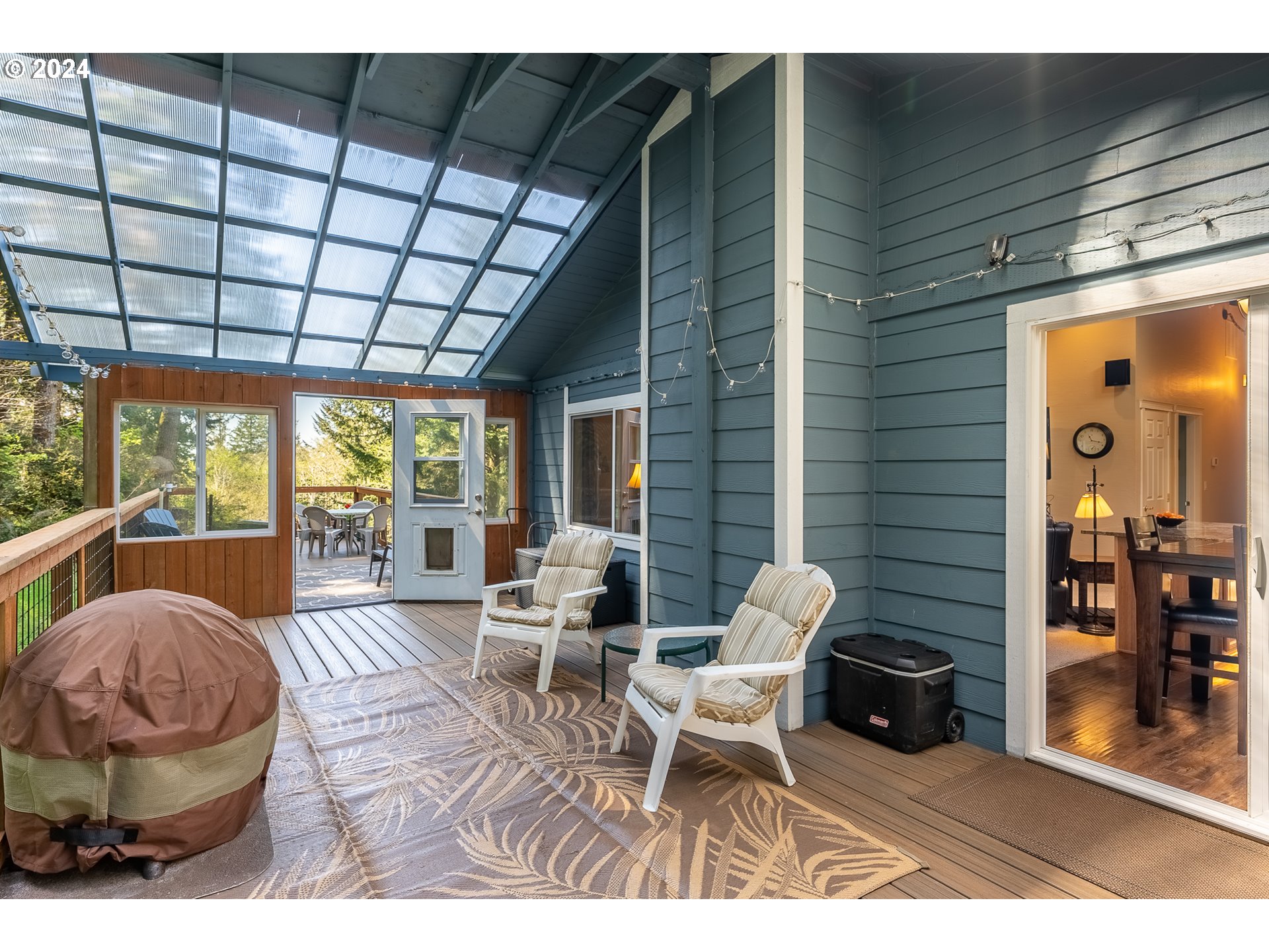 89915 Ben Bunch Road Florence, OR 97439 - Photo 28 of 33 a living room with furniture a flat screen tv and a large window