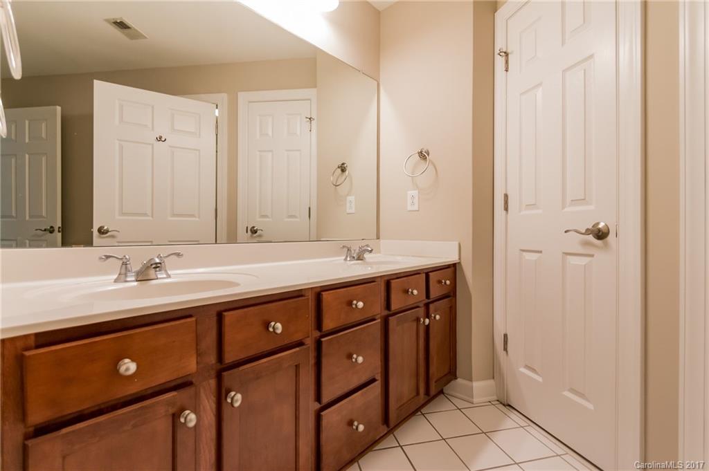 718 West Trade Street, Unit 211 Charlotte, NC 28202 - Photo 12 of 24 a bathroom with a double vanity sink and a mirror