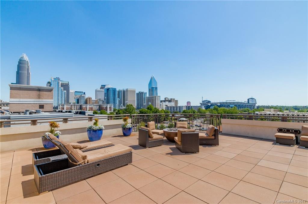 718 West Trade Street, Unit 211 Charlotte, NC 28202 - Photo 19 of 24 a view of a roof deck with couches and potted plants