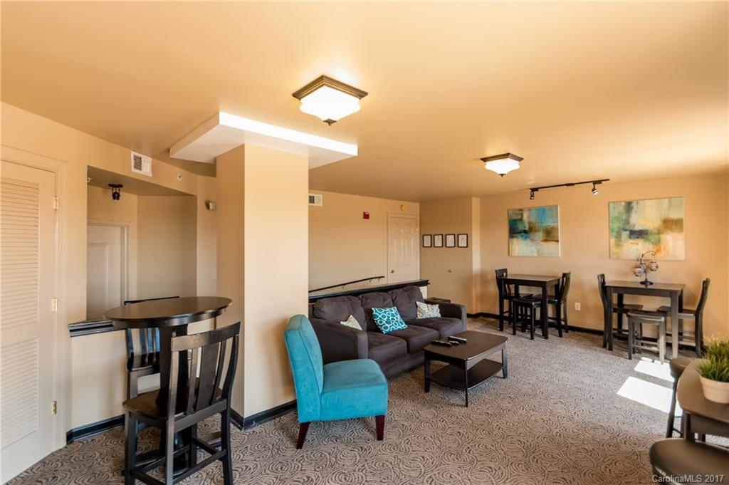 718 West Trade Street, Unit 211 Charlotte, NC 28202 - Photo 21 of 24 a living room with furniture a flat screen tv and a table