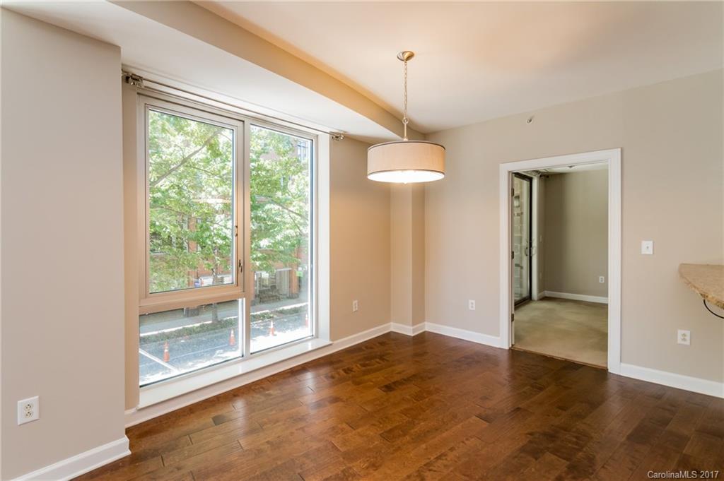 718 West Trade Street, Unit 211 Charlotte, NC 28202 - Photo 6 of 24 a view of an empty room with a window and chandelier