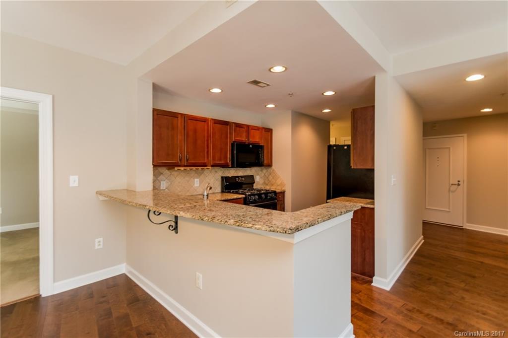 718 West Trade Street, Unit 211 Charlotte, NC 28202 - Photo 7 of 24 a view of a kitchen with kitchen