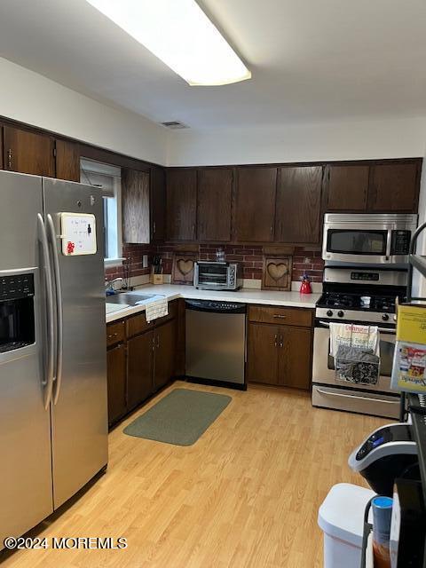 246 Greenwood Loop Road Brick, NJ 08724 - Photo 5 of 15 a kitchen with kitchen island a sink stainless steel appliances and cabinets