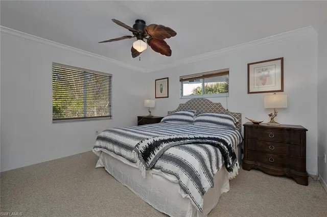 a spacious bedroom with a bed and a chandelier