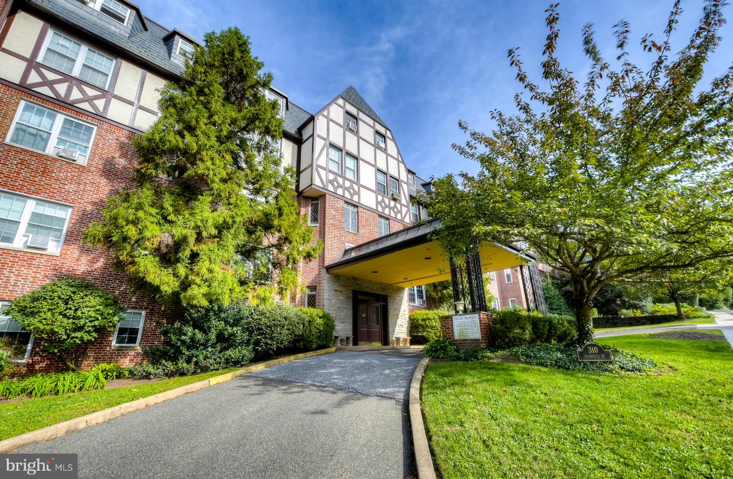 310 Ridgemede Road, Unit 203 Baltimore, MD 21210 - Photo 2 of 18 a front view of a house with a yard