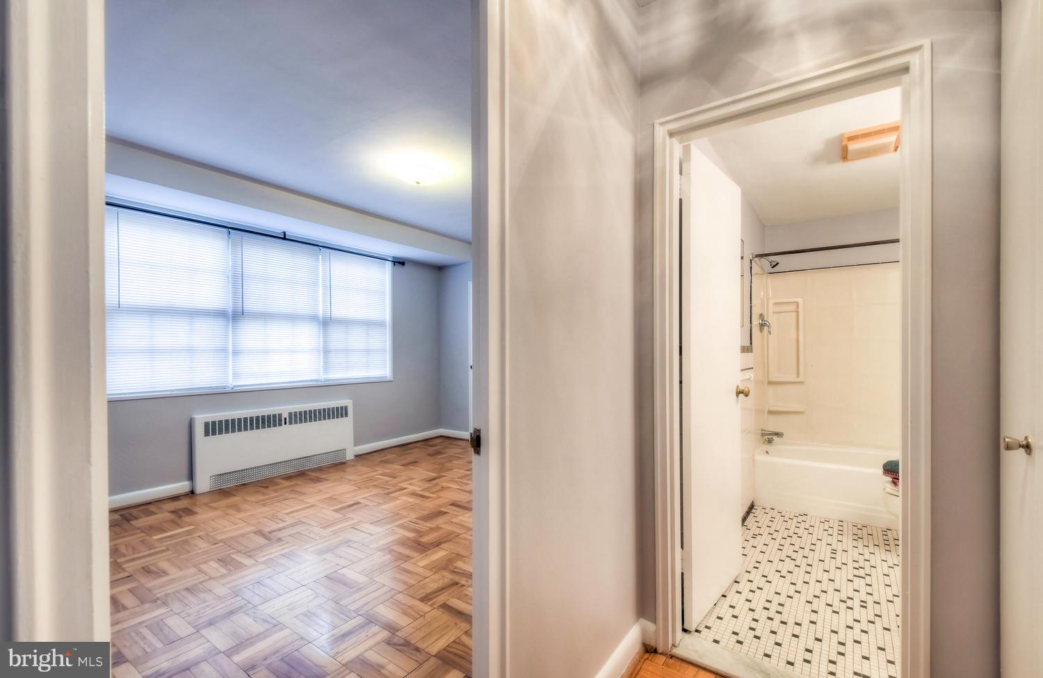 310 Ridgemede Road, Unit 203 Baltimore, MD 21210 - Photo 14 of 18 hallway with wooden floor and a window