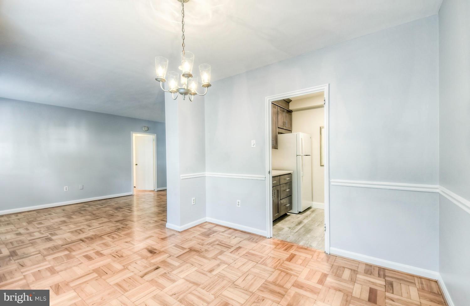 310 Ridgemede Road, Unit 203 Baltimore, MD 21210 - Photo 16 of 18 a view of a livingroom with a chandelier fan and windows
