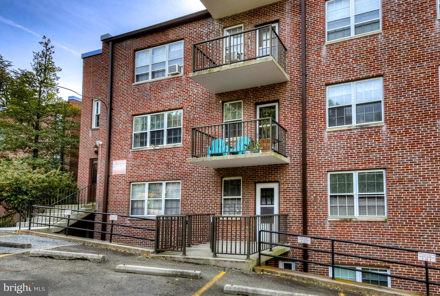 310 Ridgemede Road, Unit 203 Baltimore, MD 21210 - Photo 17 of 18 a front view of a house with a yard