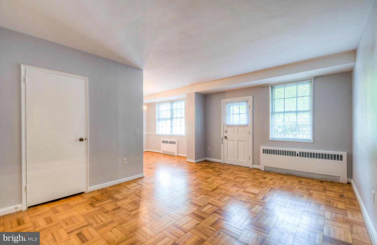 310 Ridgemede Road, Unit 203 Baltimore, MD 21210 - Photo 6 of 18 a view of an empty room with window and wooden floor