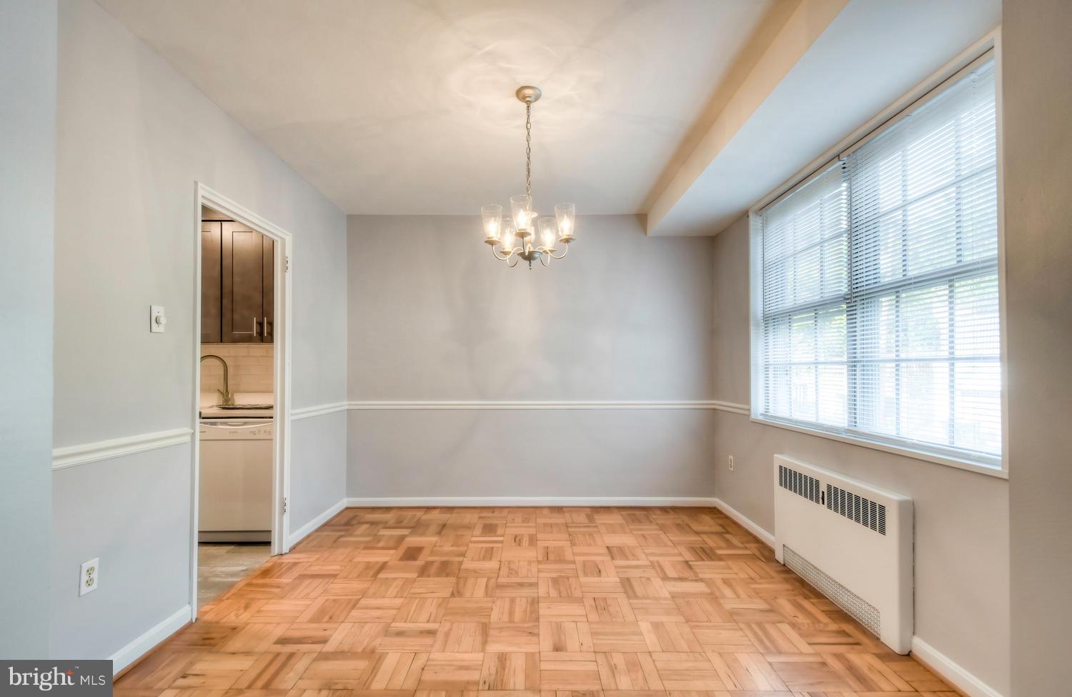 310 Ridgemede Road, Unit 203 Baltimore, MD 21210 - Photo 8 of 18 a view of empty room with wooden floor and fan