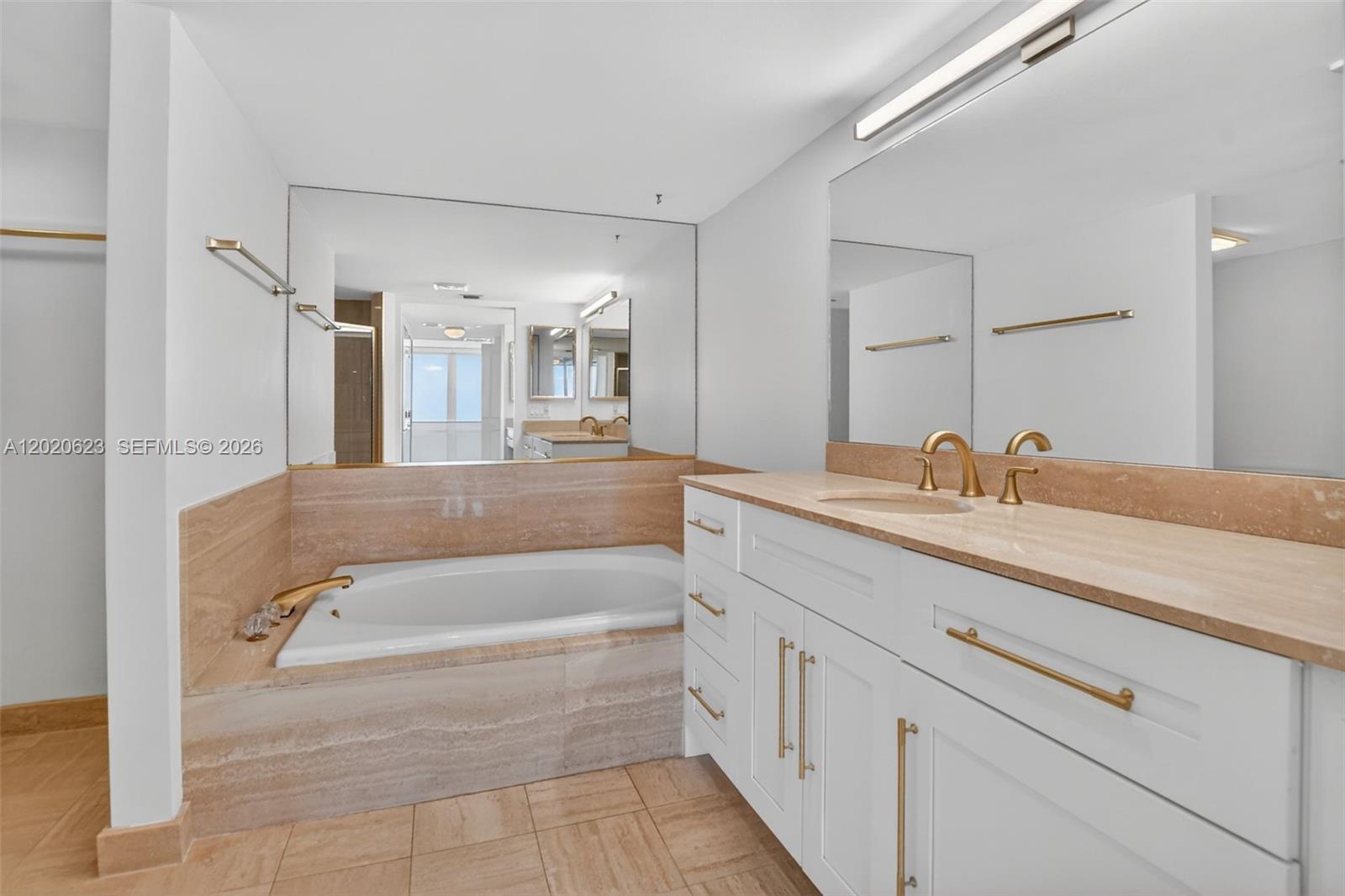 4101 North Ocean Boulevard, Unit 1605 Boca Raton, FL 33431 - Photo 25 of 35 a spacious bathroom with a tub sink and mirror