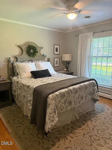 a bed sitting in a bedroom next to a window