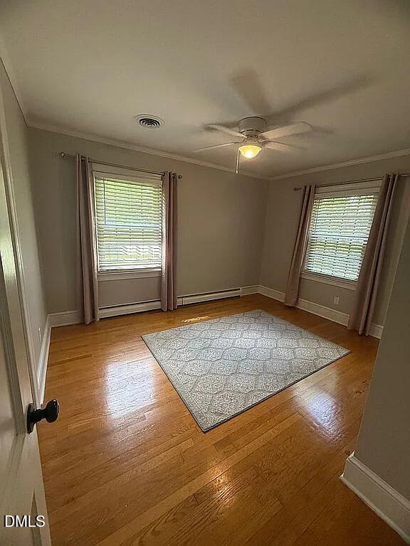 240 Crestwood Drive Roxboro, NC 27573 - Photo 13 of 25 an empty room with wooden floor and windows