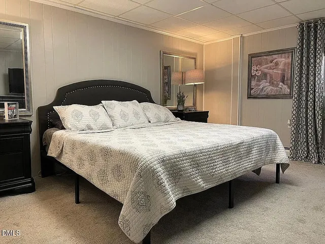 a bedroom with a bed and dresser