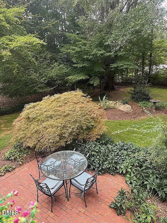 240 Crestwood Drive Roxboro, NC 27573 - Photo 21 of 25 a view of a backyard with plants and lake view