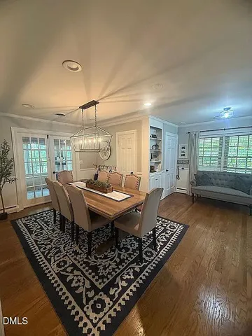 a dining room with a rug table and chairs