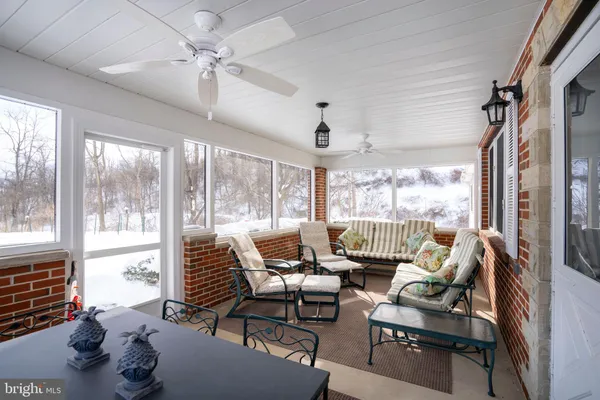 a view of a livingroom with furniture and windows