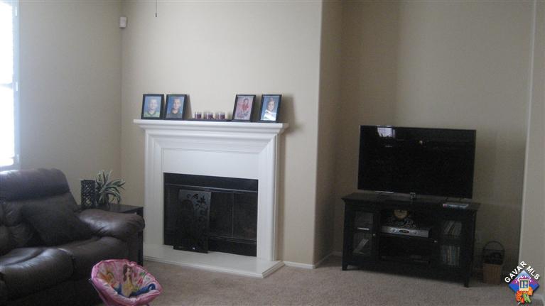 44741 Ruthron Avenue Lancaster, CA 93536 - Photo 12 of 18 a living room with furniture and a fireplace